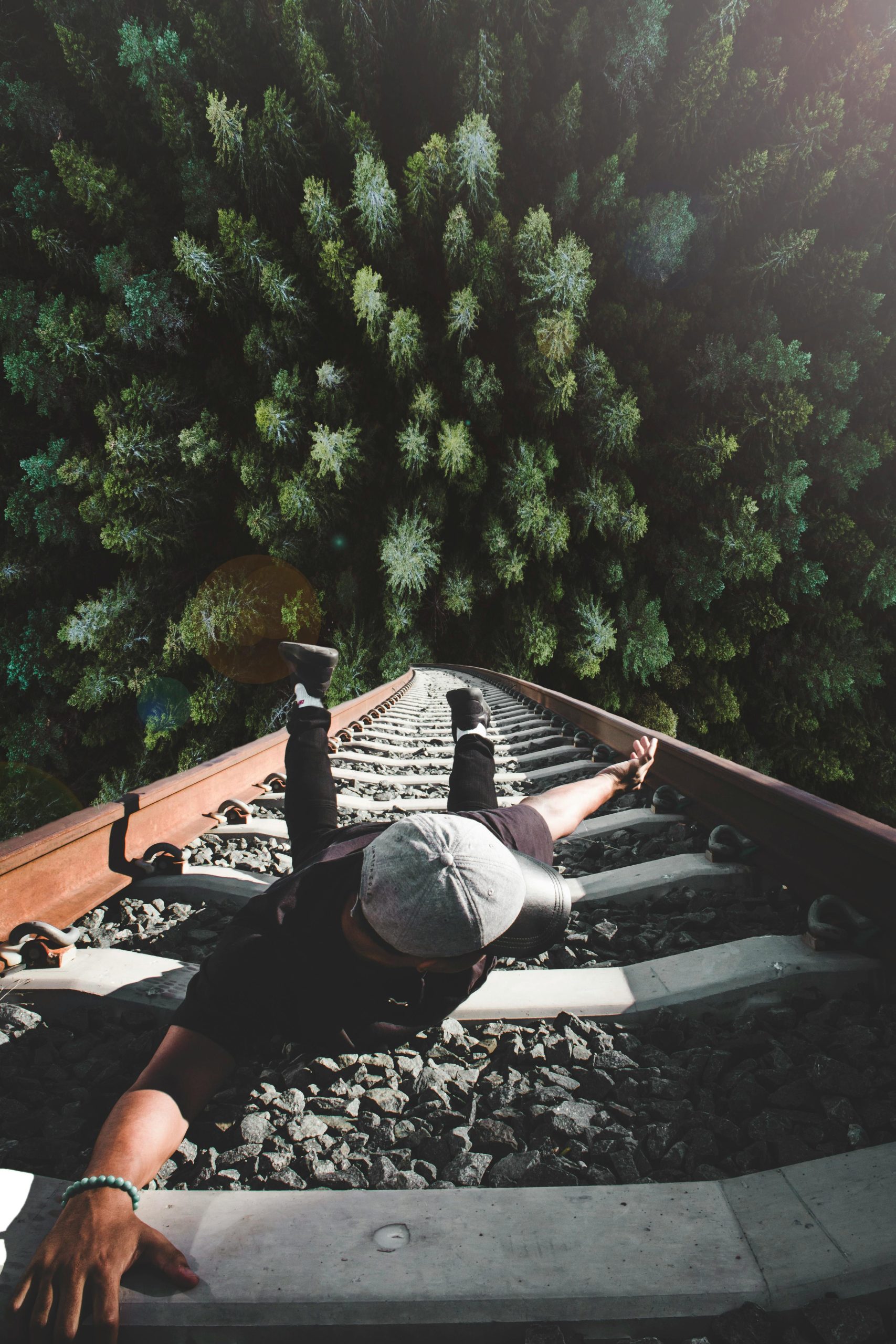 Man Holding on Gray Railing